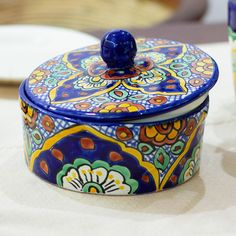 a blue and yellow box sitting on top of a table next to a white plate