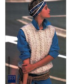 a young boy wearing a sweater vest and headband with his hands on his hips