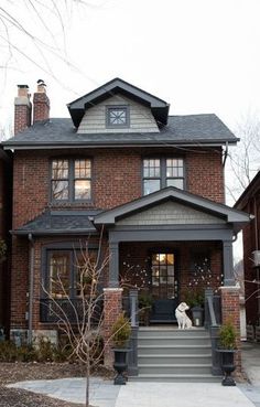 a large brick house with stairs leading to the front door