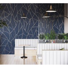 the interior of a restaurant with blue wallpaper and wooden flooring, white benches and planters