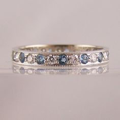 a wedding band with blue and white diamonds