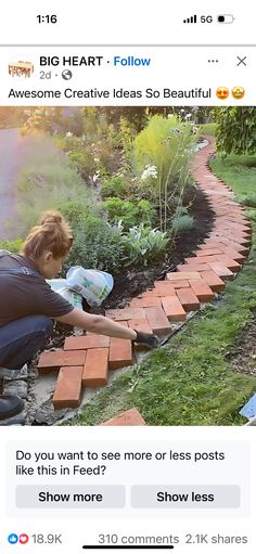 a woman kneeling down in front of a brick path with flowers and plants growing on it