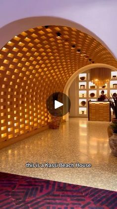 the inside of a hotel lobby with a plant in front of it and an entrance way