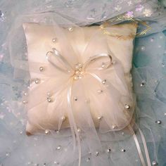 a white pillow with pearls on it