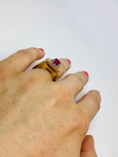 "This is a vintage 14K yellow gold, ruby, and diamond statement ring. The sharp edges of this ring give it a polished and refined look. Material(s): 14K yellow gold + (1) oval ruby + several diamonds Weight: 5.3 grams Flaws (if any): None to mention Marking(s): \"14K\" BAND SIZE 4 3/4 (or 4.75)" Formal Gold Ruby Ring With Single Cut Diamonds, Formal Yellow Gold Ruby Ring With Single Cut Diamonds, Formal 14k Gold Ruby Ring With Single Cut Diamonds, Vintage Gold Ruby Ring With Single Cut Diamonds, Vintage Yellow Gold Ruby Ring With Single Cut Diamonds, Vintage Gold Ruby Ring With Vvs Clarity, Vintage 14k Gold Ruby Ring With Polished Finish, Antique 14k Gold Hallmarked Ruby Ring, Antique 14k Gold Ruby Ring Hallmarked