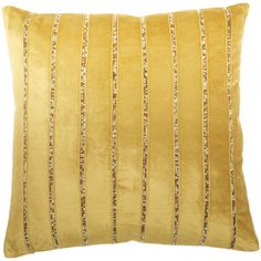 a yellow velvet pillow with gold sequins on the side and a white background