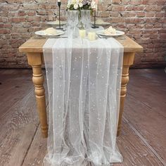 the table is set with white flowers and candles