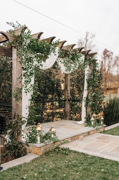 an outdoor ceremony setup with greenery and candles