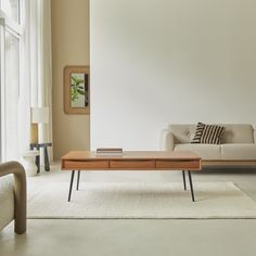 a living room with a couch, coffee table and chair