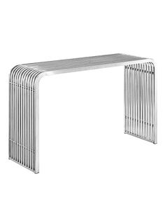 a white metal bench sitting on top of a white floor