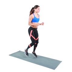 a woman is running on a yoga mat