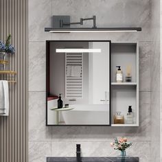 a bathroom sink sitting under a mirror next to a wall mounted faucet in front of a bath tub