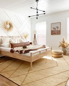 a bedroom with a bed, rugs and two lamps on the side of the room