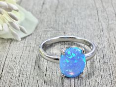 Opal Ring / Opal Ring Silver / Opal Oval Ring / Gifts for Women /Women's Opal Ring/ Sterling Silver Opal Ring Blue, oval shaped, opal set in Sterling Silver. The colors are very pretty with flashes of blue, aqua and green. Simple and dainty. Perfect for everyday wear. 8mm Lab created opal, 2mm sterling silver band. Thanks so much for stopping by. Feel free to contact me with any questions. More jewelry from Penelope's Porch: https://www.etsy.com/PenelopesPorch Opal Ring Silver, Sterling Silver Opal Ring, Australian Opal Ring, Blue Opal Ring, Black Opal Ring, Silver Opal Ring, Precious Opal, Ring Gifts, Ring Opal