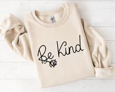 a sweatshirt with the words be kind printed on it