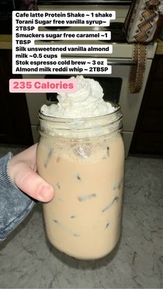 a person holding a jar with whipped cream in it and the caption reads, coffee latte protein shake