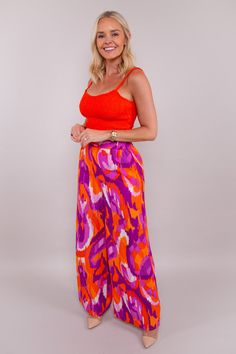 These high-waisted pants feature a delightful blend of bright orange and dreamy purple hues, exuding a sense of joy and style. The flowy silhouette adds an air of elegance, while the elastic waistband and practical pockets ensure both comfort and functionality. Step into the magic of colors and embrace effortless confidence and flair. 🧡💜 100% Polyester Made with love in the U.S.A. Hand Wash Cold Colors may vary with different viewing devices. Vibrant Wide Leg Summer Pants, Vibrant Pants For Spring Vacation, Vibrant Spring Vacation Pants, Vibrant Summer Pants With Vibrant Print, Vibrant Print Summer Pants, Purple Beach Pants For Spring, Purple Pants For Spring Beach Outing, Orange Summer Pants For Day Out, Orange Wide-leg Summer Bottoms