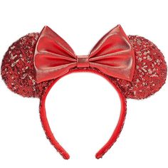 a red minnie mouse ears headband with sequins and a large bow at the top