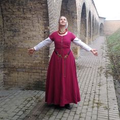 Made on the most common patterns of the Burgundian medieval gowns. It is a good choice for a Medieval festivals and dance events on the period. I both can be a peasant costume or town gown. The kirtle is made of wool and the bodice is strengthen by contrast linen lining. It is fitted due to the front lacing. The cord is hand made and there is an option to chose a rings or hand sewn holes for lacing. Note, the chemise is not included in the listing. The custom copy and different materials is avai Tudor Kirtle Pattern, Fitted Peasant Medieval Dress With Long Sleeves, Viking Style Medieval Dress For Costume Parties, Viking Style Medieval Dress For Festivals And Costume Parties, Medieval Dress For Larp And Medieval Festivals, Medieval Dress With Historical Design For Fantasy Events, Medieval Dress With Historical Design For Festival, Medieval Style Fitted Dress For Medieval Festivals, Medieval Style Dress For Medieval Festivals