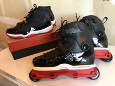 two pairs of black and red roller skates sitting on top of a white table