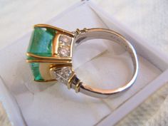 Simply sublime. This unique ring is the highlight of my Etsy collection. A rare stunner with an 8+ carat emerald and one carat total weight in white diamonds. This was a custom handmade ring I helped to design, and picked the stones myself, a rectangular shape natural emerald, gauging 13.00 x 10.40 x 9.00mm, exact weight 8.13 carats. 10 round brilliant cut diamonds accent the ring. One of the premier jewelers here in Wine Country made it; the top in pure 18K yellow gold and the shank in platinum Luxury Green Diamond Ring For Anniversary, Emerald Cut Diamond Ring For Evening, Luxury Hallmarked Emerald Ring With Diamond, Formal Emerald Diamond Ring With Vvs Clarity, Luxury Green Diamond Ring For Formal Occasions, Luxury Green Emerald Hallmarked Ring, Luxury Brilliant Cut Emerald Ring For Formal Occasions, Formal White Gold Emerald Ring With Vvs Clarity, Luxury Oval Emerald Ring Collectible