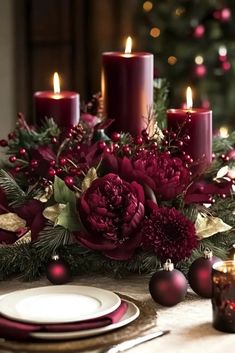 a christmas table setting with candles and flowers