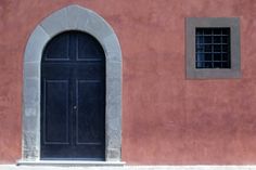 a red building with a black door and window