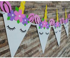 paper bunting with unicorn ears and flowers on it