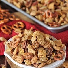 a plate full of cheetos and pretzels next to some other snacks