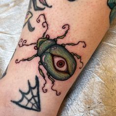 a close up of a person's leg with tattoos on it and an eye in the center