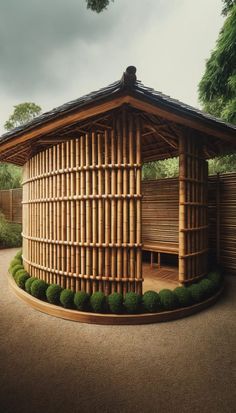 a wooden gazebo sitting on top of a lush green field next to a forest