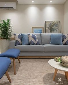 a living room with blue and white furniture