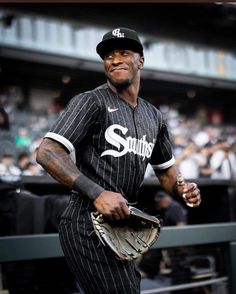 a baseball player holding a catchers mitt in front of a crowd