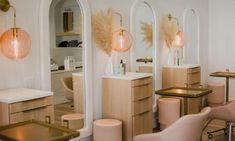 the interior of a hair salon with chairs and mirrors