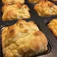 three muffins sitting in a baking pan on top of a counter next to each other