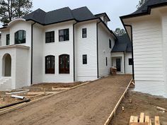 a large white house under construction with lots of windows