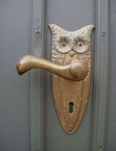 an owl shaped door handle on a gray door