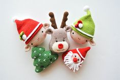 three knitted animals wearing christmas hats on top of each other