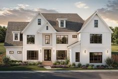 a white two story house with lots of windows on the front and side of it