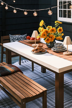 a table with sunflowers and plates on it