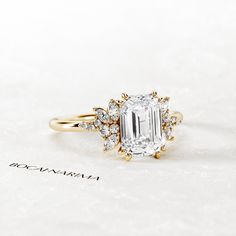 an engagement ring with a large diamond surrounded by smaller diamonds