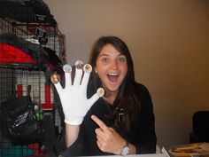 a woman sitting at a table with fake hands