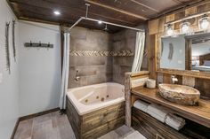 a bathroom with a sink, mirror and bathtub inside of it next to a walk in shower