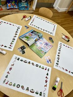 the table is covered with paper cutouts and crafting supplies for children to make