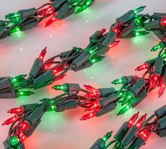 several green and red christmas lights on a white surface