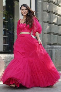 Fuchsia pink tiered lehenga. Paired with a strapless padded blouse with floral embroidery. Comes along with detachable puff sleeves and ruffle trim dupatta. - Aza Fashions Floor-length Pink Lehenga With Ruffles, Pink Floor-length Ruffled Lehenga, Pink Fitted Organza Skirt, Pink Floor-length Sharara With Ruffles, Pink Ruffled Lehenga For Party, Pink Fitted Sharara With Unstitched Blouse, Pink Ruffled Sharara For Wedding, Pink Ruffled Choli For Wedding, Pink Party Skirt Set With Pallu