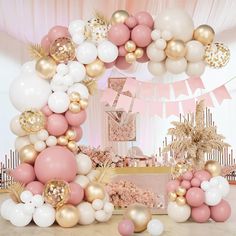 a pink and gold birthday party with balloons