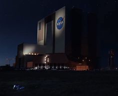 an image of the outside of a building at night with stars in the sky above