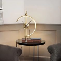 a small table with a clock on it next to a chair