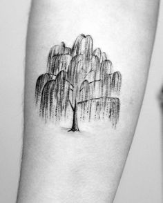 a black and white photo of a tree tattoo on the right arm with water droplets coming from it